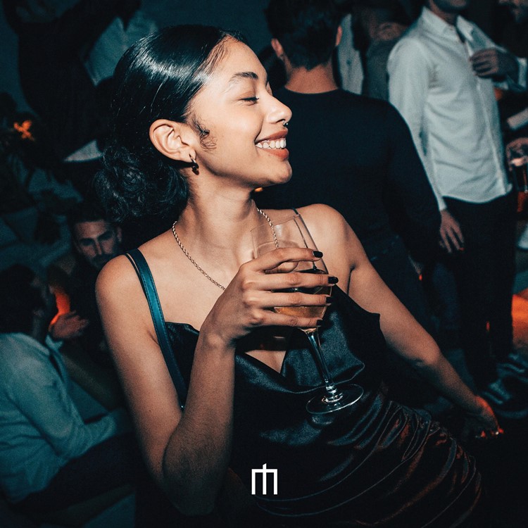 Moloko Pigalle nightclub in Paris pretty brunette girl having fun drinking cocktail guest list