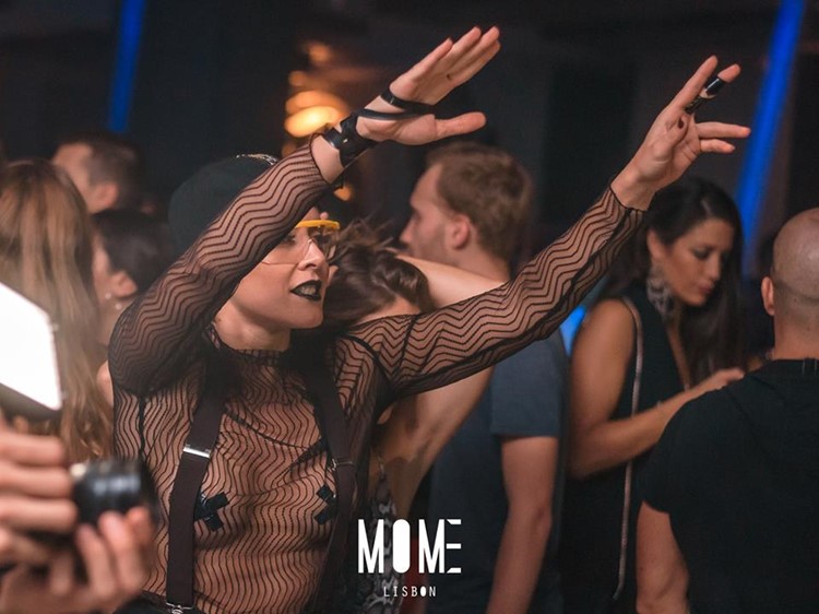 Mome nightclub Lisbon girl having fun dancing drinking
