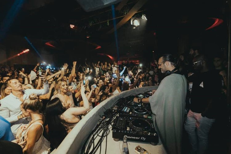 Momento nightclub Marbella dj mixing music crowd dancing on the dance floor event show the place to be