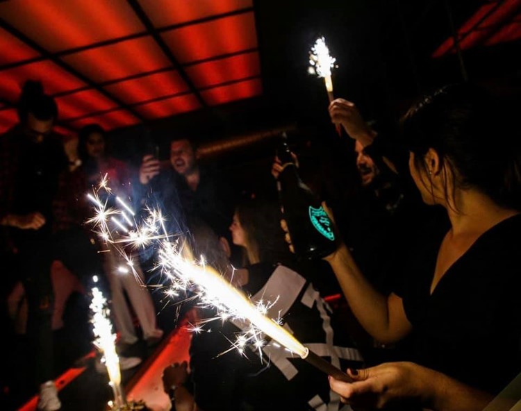 Mosh fun Kitchen club Marbella alcohol bottles table service vodka rum champagne confetti fun party