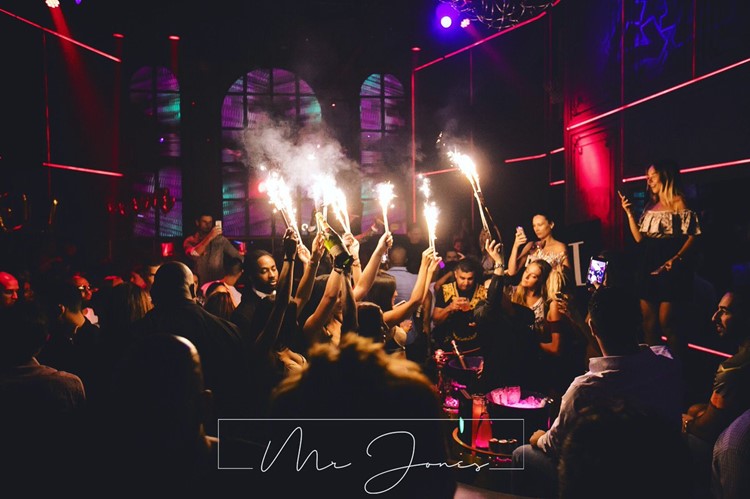 Mr Jones nightclub Miami party crowd drinking champagne bottles