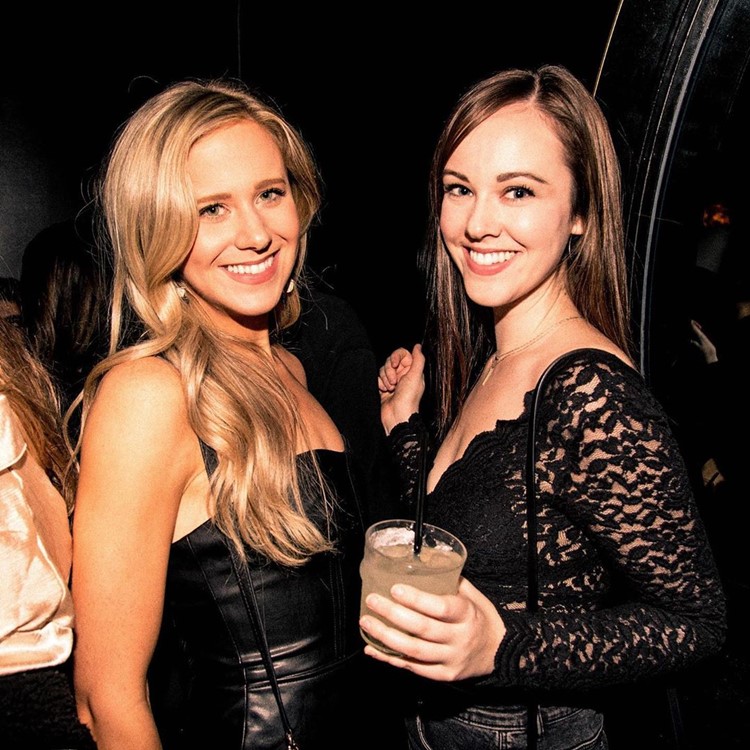 Noir nightclub New York City ladies having fun blonde brunette girls drinking cocktails guest list night