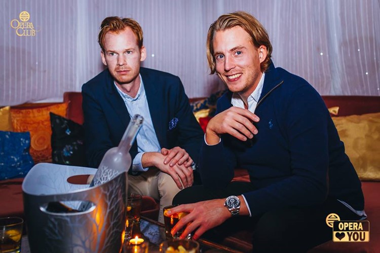 Opera Club nightclub Warsaw two rich handsome men drinking vodka alcohol bottle service vip table