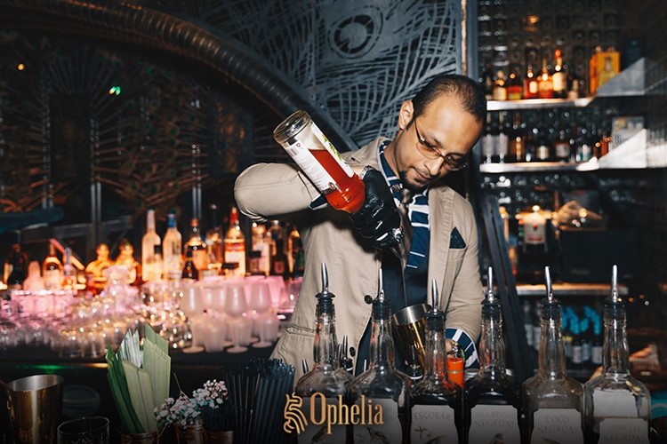 Ophelia nightclub Hong Kong barman mixing drinks pouring shots alcohol bottles gin rum vodka packages