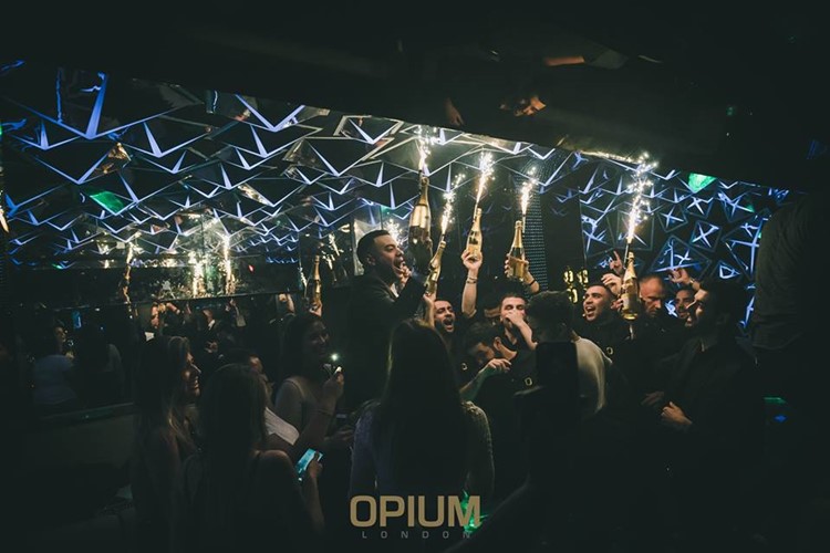Opium nightclub London fun table service alcohol bottles vodka rum champagne expensive celebration 
