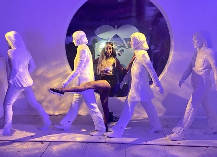 Pacha nightclub Ibiza girl posing next to white statues dance move