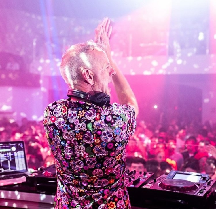 Pacha nightclub Ibiza dj clapping hands and singing music to big crowd