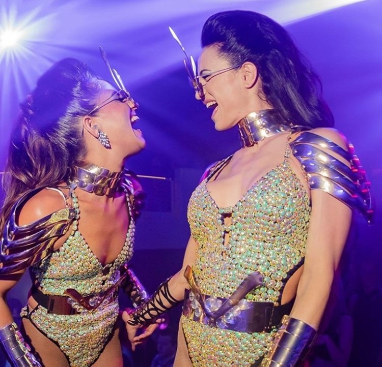 Pacha nightclub Ibiza two brunette girls wearing costumes gladiator shiny swimsuits