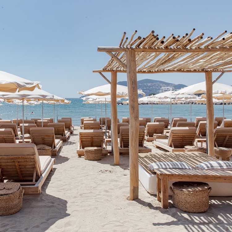 Playa Chica beach club Cannes sun loungers day time holiday party relax in the sun