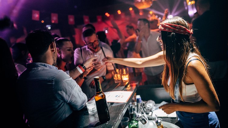 Plaza Klub nightclub Zurich sexy bartender serving alcohol drinks bottles vodka champagne