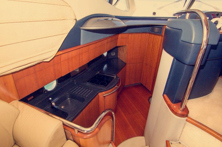 Private boat Dubai rental indoor couch kitchen 