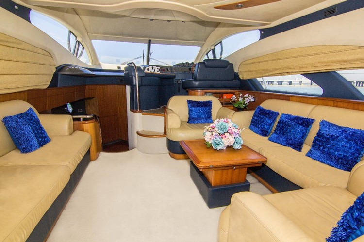Private boat Dubai rental indoor couch lounge luxury boat spacious
