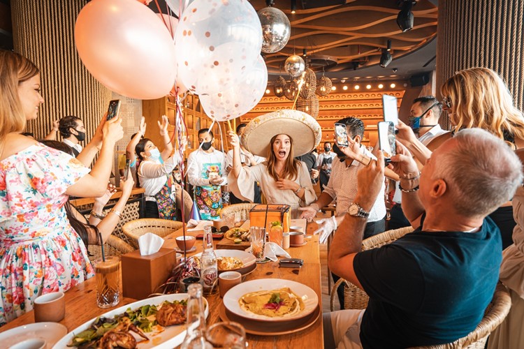 Puerto 99 restaurant Dubai fun party celebrate birthday balloons champagne parade food fun 