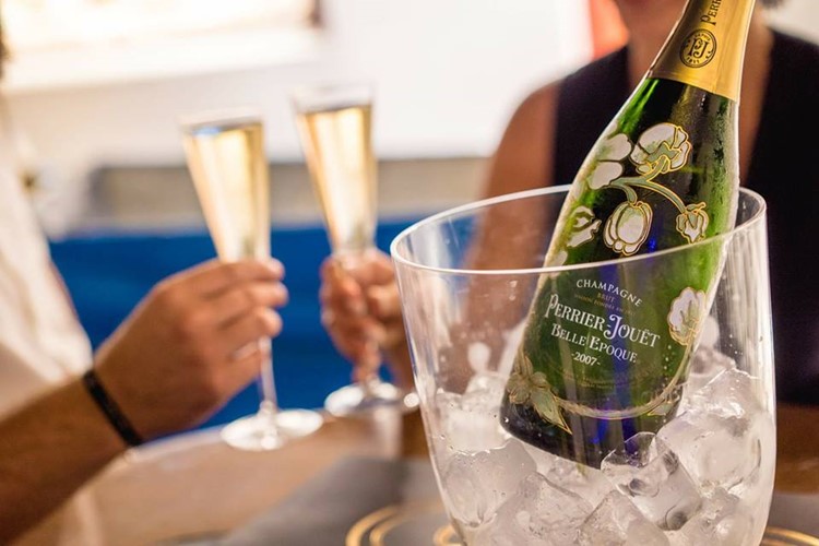 Queen of Mykonos nightclub bottle of champagne Perrier-Jouet being served at an event