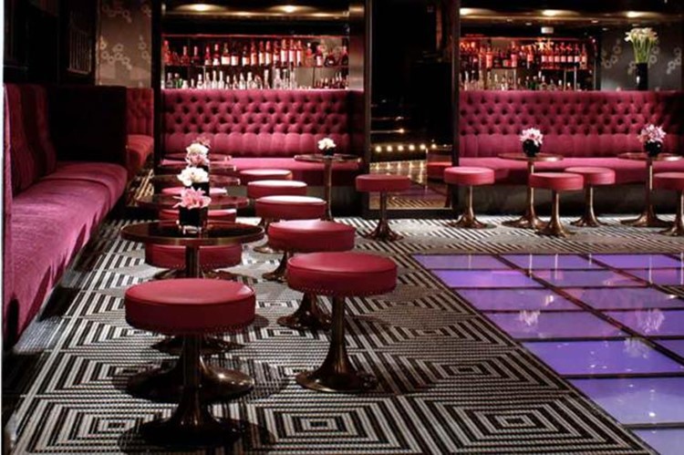 raffles nightclub london view of the entire club elegant luxury interior design colorful patterns black white purple and blue