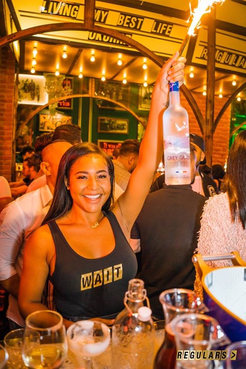 Regulars Bar club Toronto sexy waitress serving alcoholic drinks