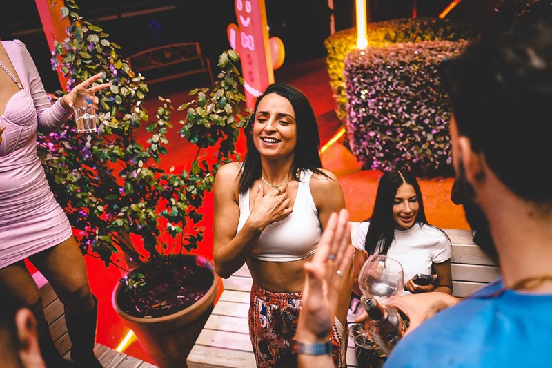 Rose Bonbon club Paris girl in swing chair guest list fun night party event white mini dress