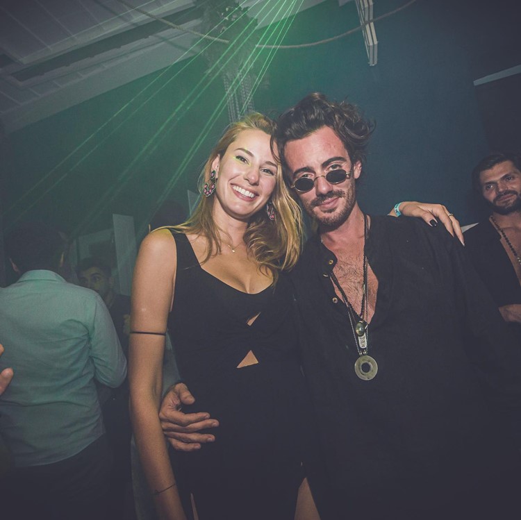 Sanctus nightclub Mykonos pretty girl with guy having fun partying clubbing book your vip table