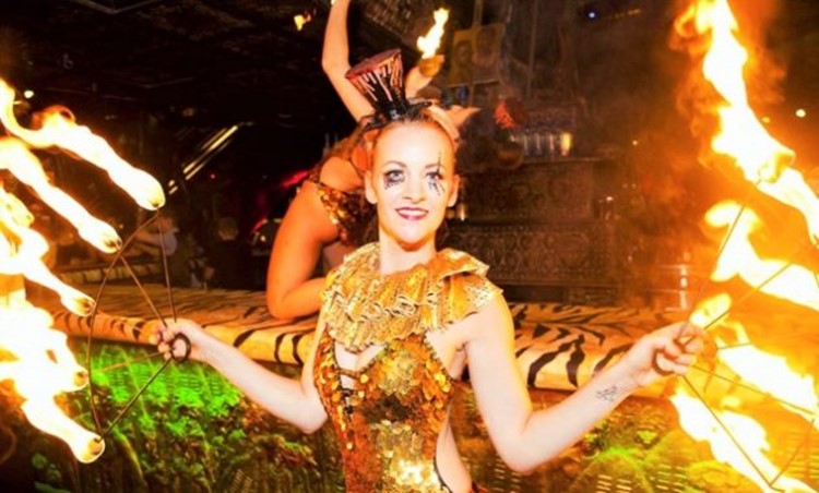 Shaka Zulu London restaurant club acrobats dressed in gold glitter jungling with fire