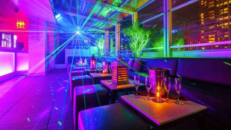 Sky Room nightclub New York City rooftop club view of the inside lounge area colored lights
