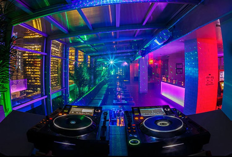 Sky Room nightclub New York City rooftop club inside rooms dj view dance floor colored lights