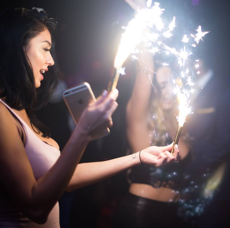 Somwhr Liquor Lounge nightclub Montreal brunette girl holding firework