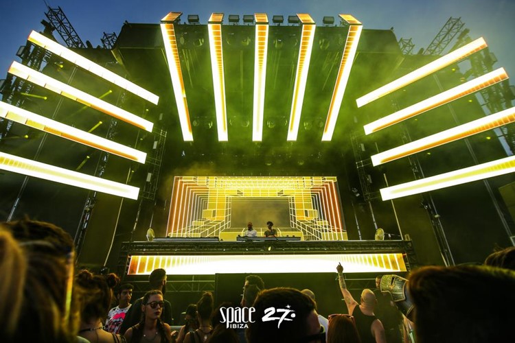 Space nightclub Ibiza concert stage famous djs party crowd having fun