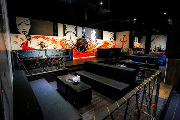 Stadium nightclub Toronto view of lounge area abstract painted walls orange red black interior design