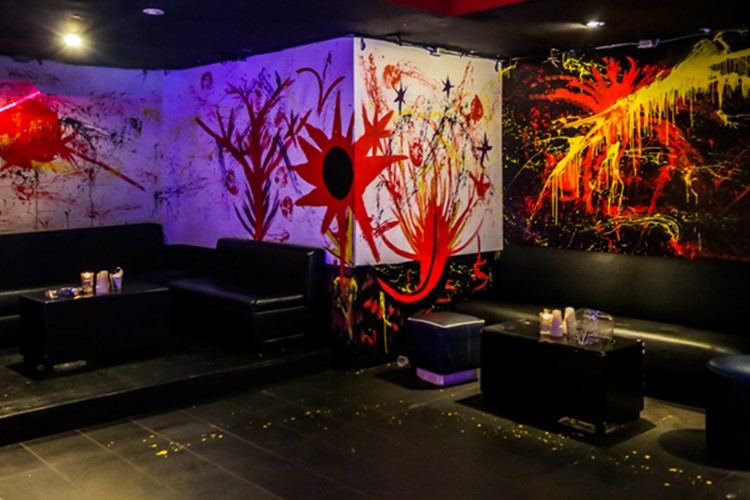 Stadium nightclub Toronto view of lounge area abstract painted walls orange yellow red black interior design