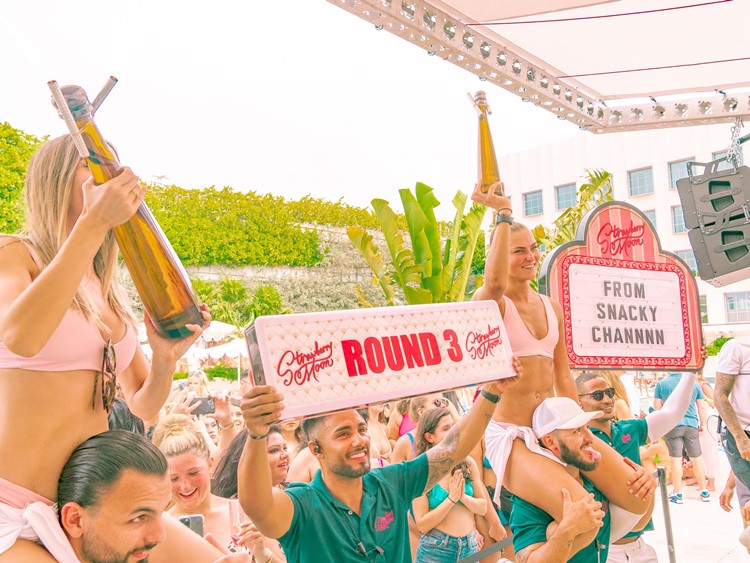 Strawberry Moon pool club Miami champagne bubbles bottles parade celebration
