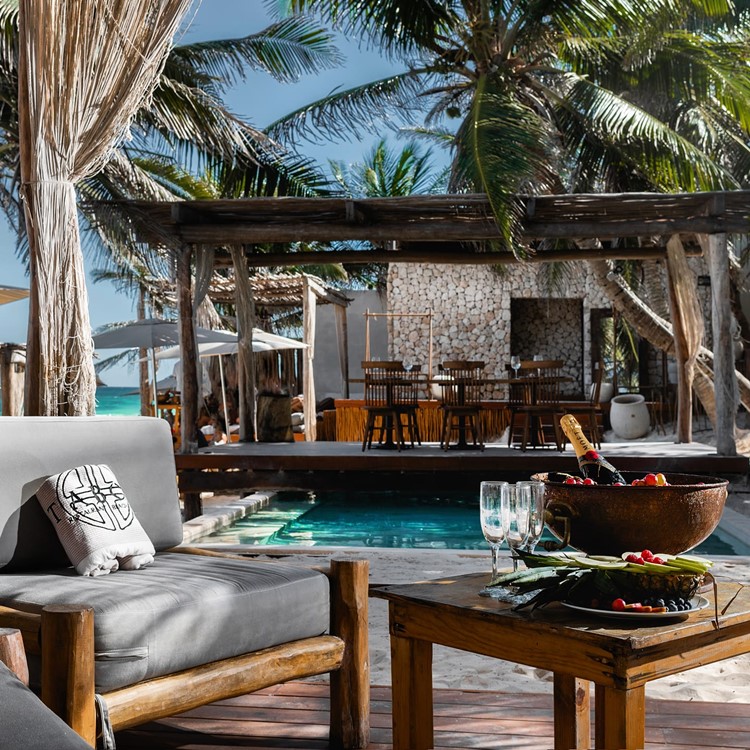 Taboo beach club in Tulum swimming pool lounge couch day bed sunbed reserve
