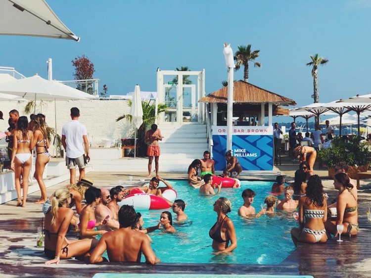 Tamaris beach club Cannes people having fun playing in the water girls in bikinis partying