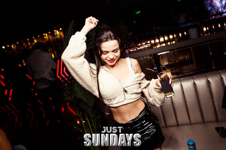 The Avenue club in Dubai pretty brunette girl dancing cocktails fun 