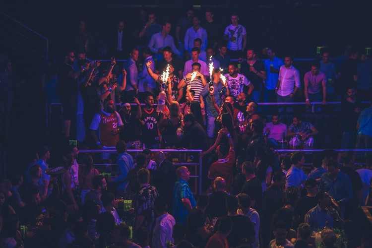 The City nightclub Cancun people partying table bottle service alcohol vodka champagne celebrate