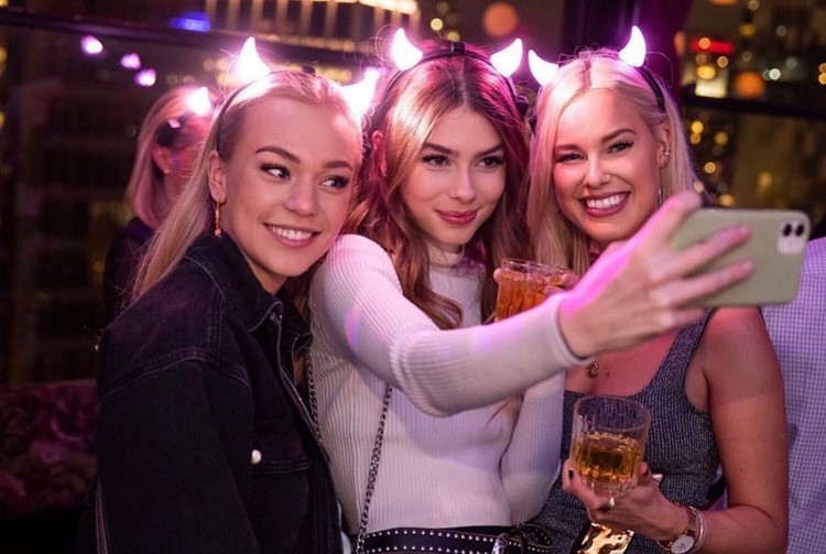 Fleur Room club in NYC pretty blonde girls selfie clubbing devil horns