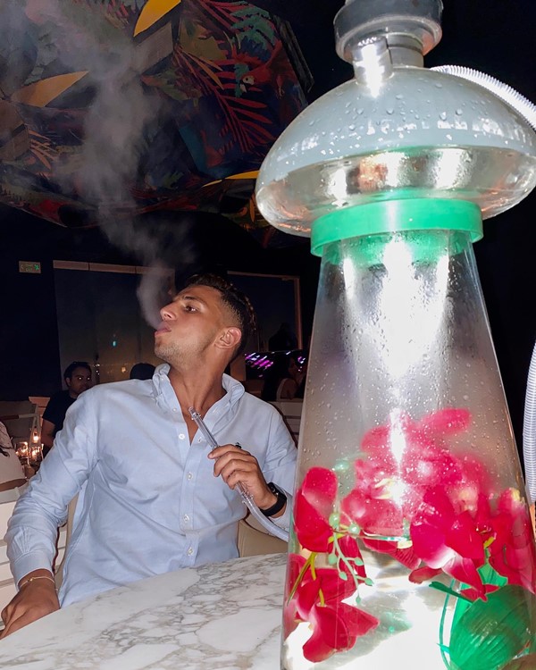 The Penthouse night club Dubai guy smoking hookah sheesha fun party event nightclub go out tonight where event