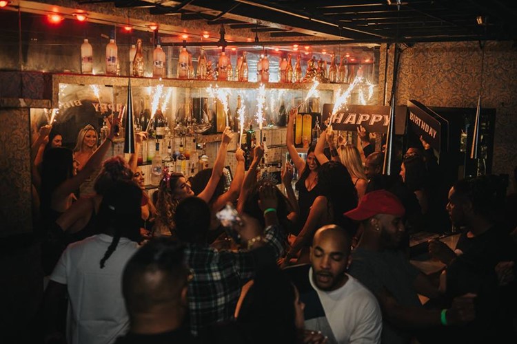 Tier Club nightclub Orlando waitresses holding champagne bottles celebrating