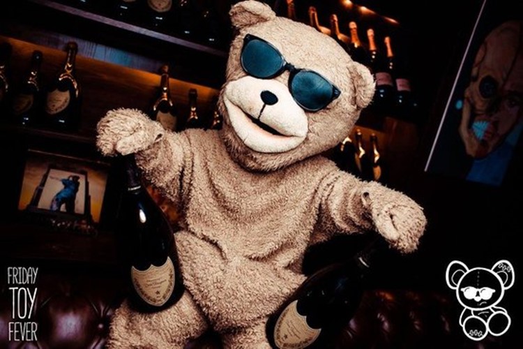 Toy Room nightclub Dubai mascot teddy bear holding champagne bottles