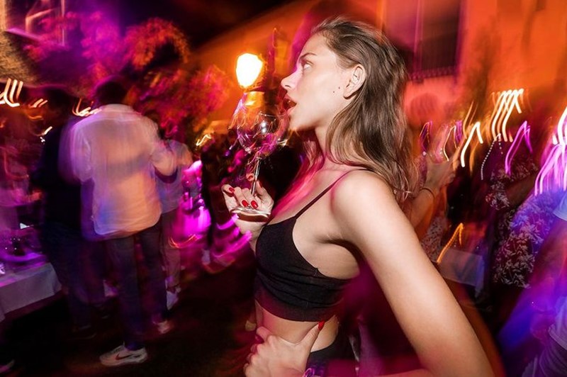 vip room st tropez nightclub beautiful blonde girl dressed in silver crop top drinking champagne at a party