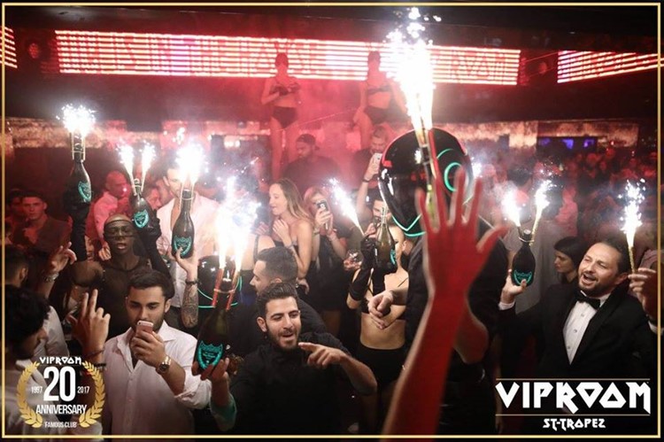 vip room st tropez nightclub private vip night party celebrating with many alcohol champaigne bottles rich men having fun