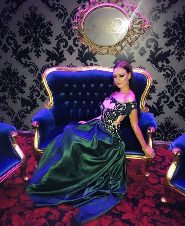 VIP Room nightclub Paris pretty brunette girl dressed in elegant emerald green long dress