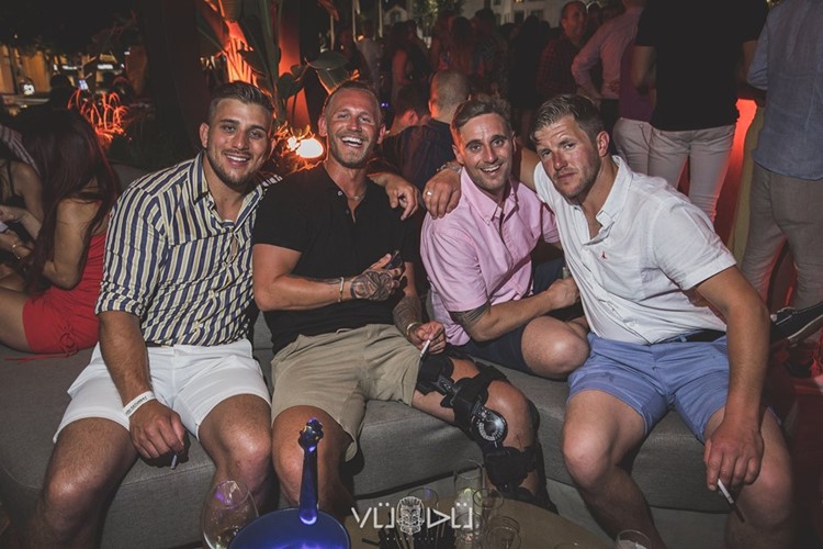 Vudu nightclub Marbella men having fun table booking reserve book now alcohol bottles champagne vodka drinks