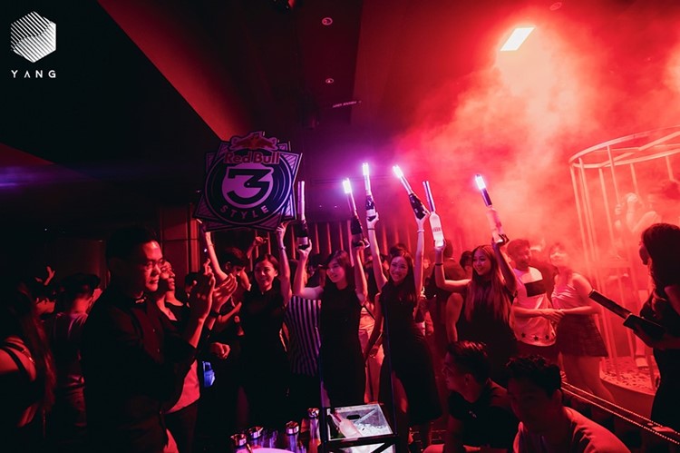 Yang nightclub Singapore people celebrating alcohol bottles experience champagne vodka gin rum book your own vip table now